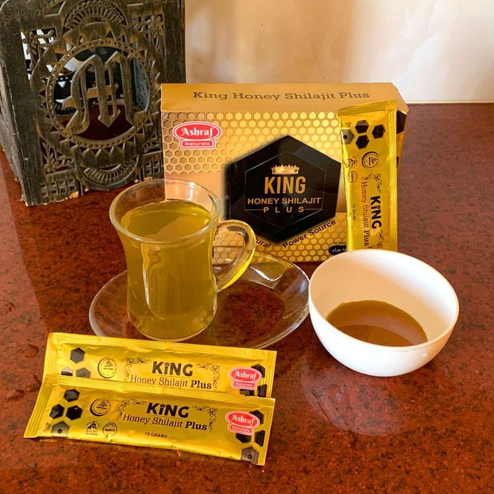 A cup of tea and a packet of King Honey.